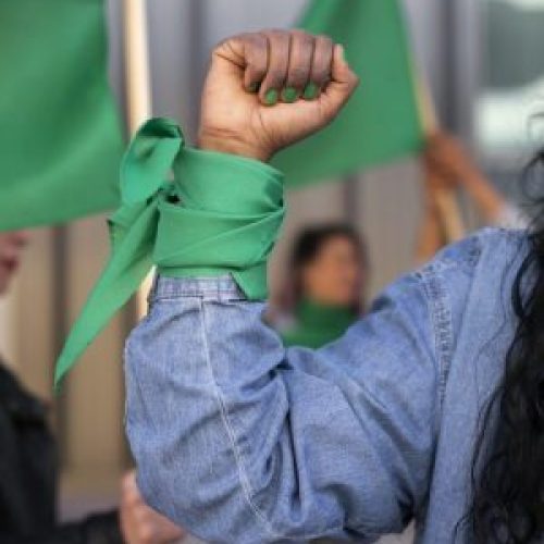 front-view-woman-protesting-outdoors