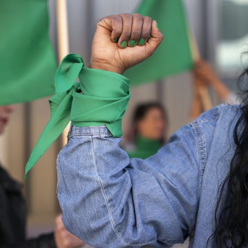 front-view-woman-protesting-outdoors